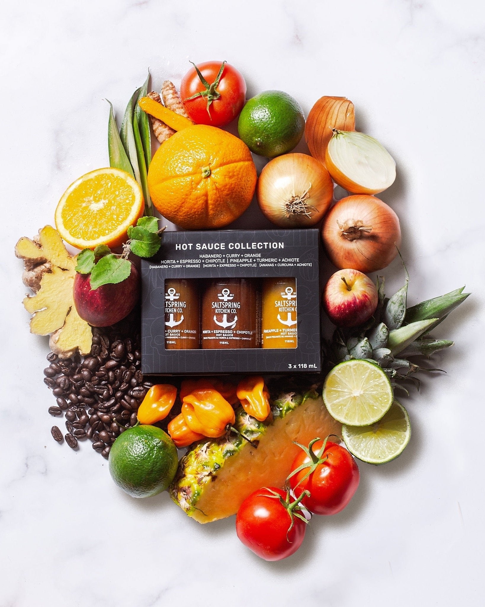 Salt Spring Kitchen Company Hot Sauce Collection Trio Gift Box with ingrediants in a flat lay