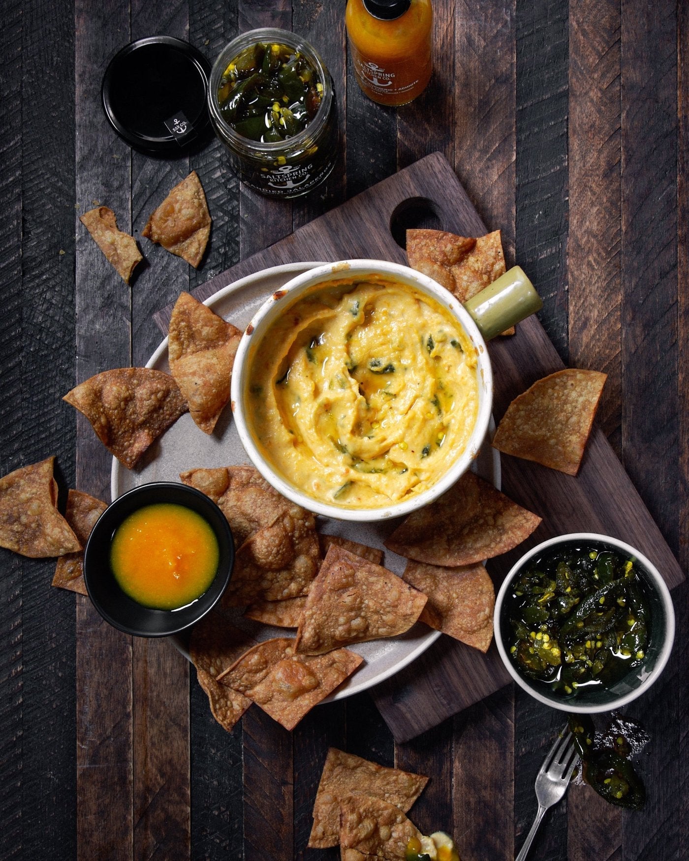 Salt Spring Kitchen Company Pineapple Turmeric Achiote Hot Sauce with queso dip and candied jalapenos